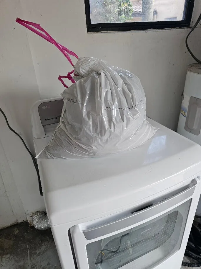 Dryer lint pulled from a dryer vent filling an entire trash bag